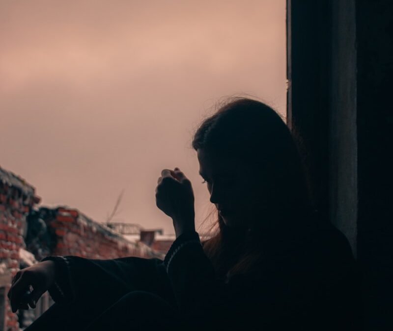 a man sitting in a window